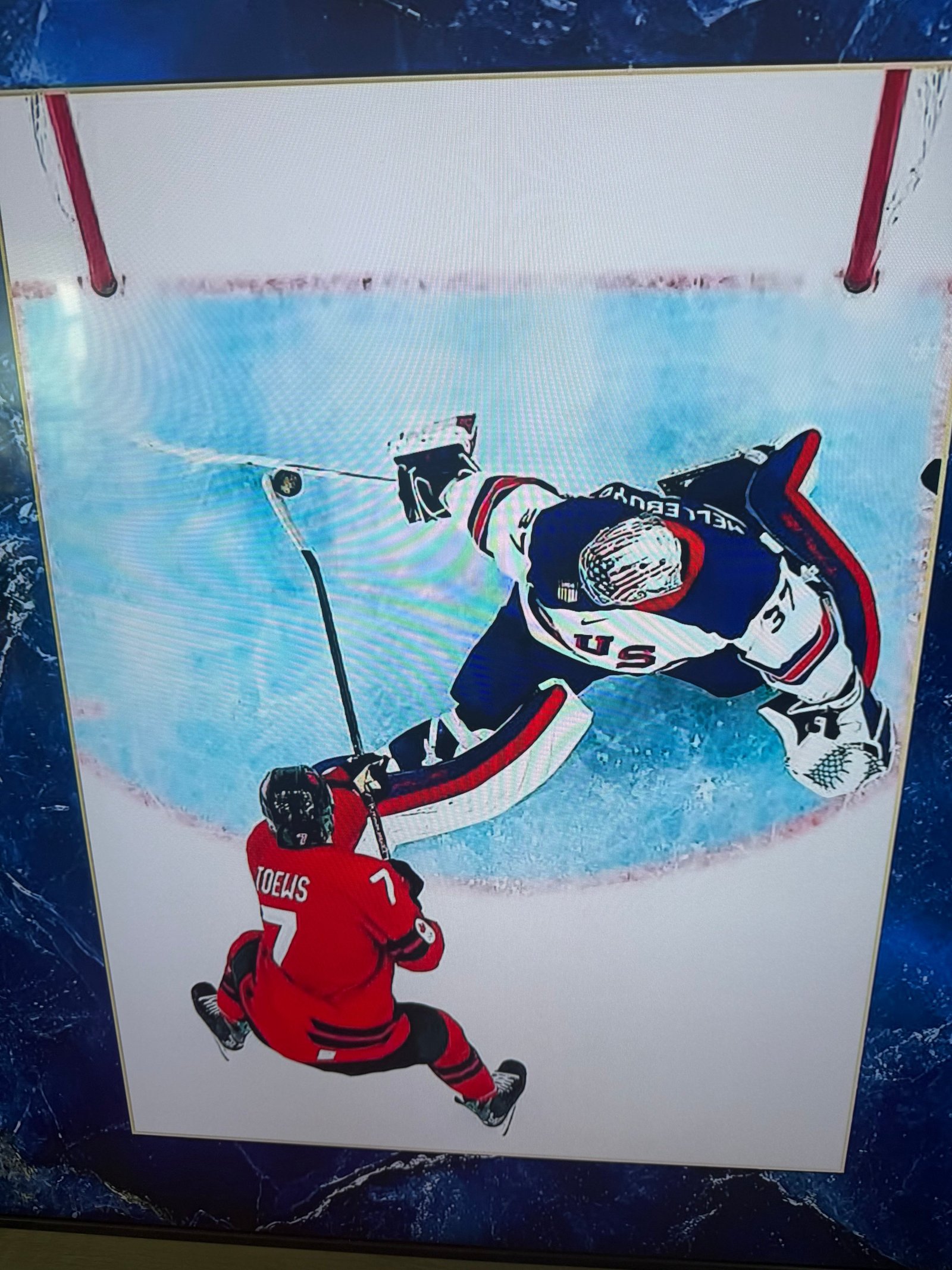 Team USA goaltender Connor Hellebuyck makes a sprawling save against Canada in the 2026 Olympic gold medal game