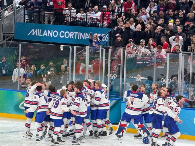 Team USA ice hockey players celebrate together on the ice at the Milano Cortina 2026 Olympic gold medal game