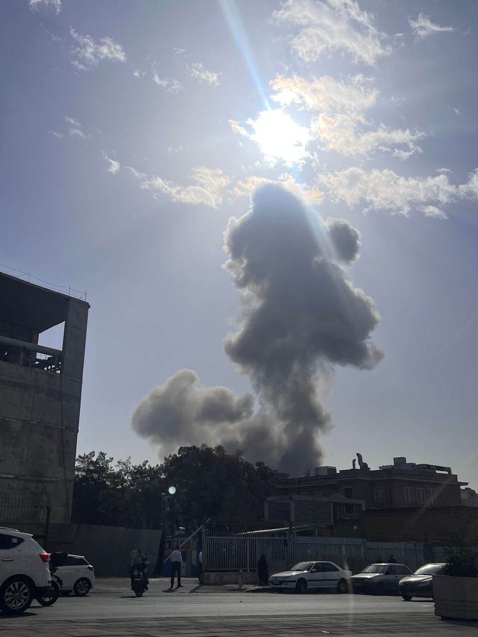Dual smoke columns rising over Tehran streets following US Israel Operation Shield of Judah strikes February 28 2026