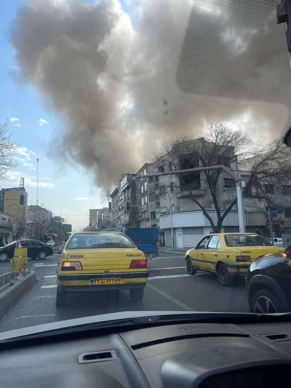 View from inside a car in Tehran as massive smoke plume rises from strike zone, February 28 2026