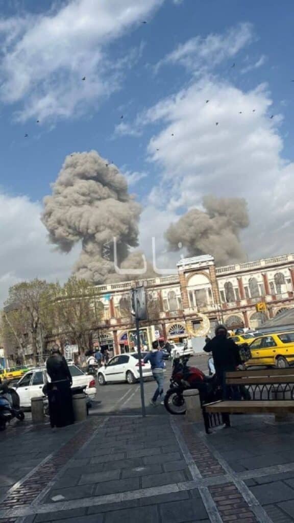 Massive smoke plumes rising over Imam Khomeini Square in Tehran following US and Israel Operation Shield of Judah strikes, February 28 2026