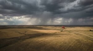 Aerial view of American farmland with foreign ownership flag visible on fence post