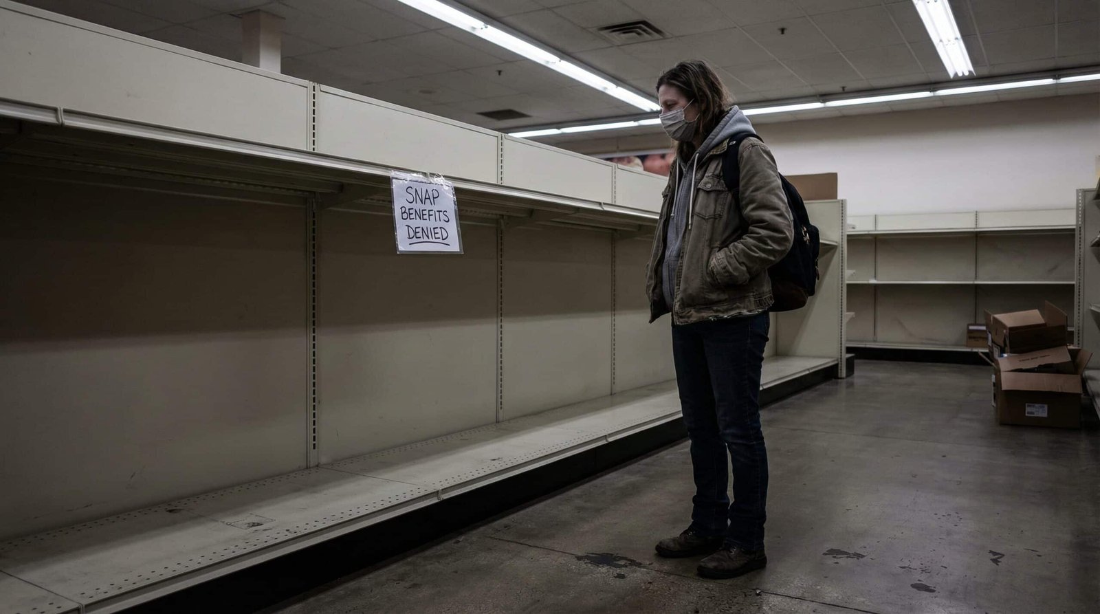 Millennial woman facing empty grocery shelves after SNAP food stamp benefits denied in 2026